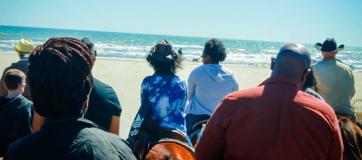 Group horseback ride on the beach